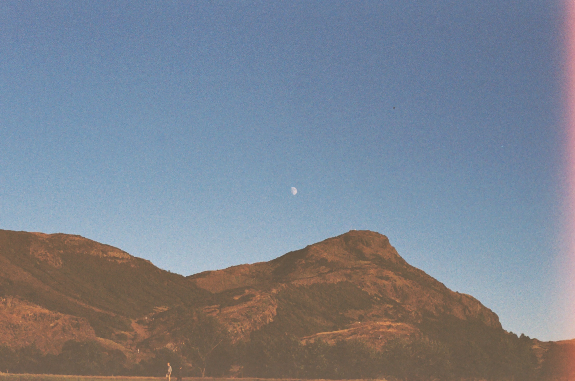 A picture of the moon over Arthurs Seat